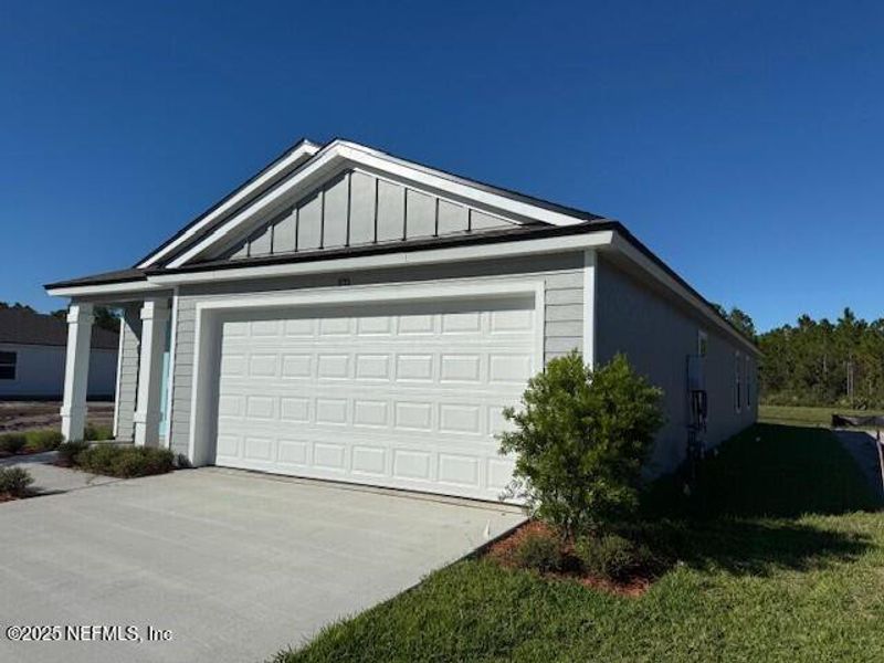 Front exterior of a new home in Grand Reserve, Bunnell, FL, highlighting curb appeal (Image 28).