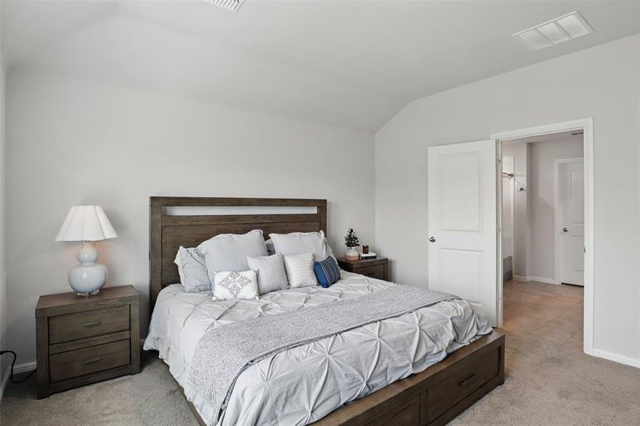 Primary bedroom featuring lofted ceiling