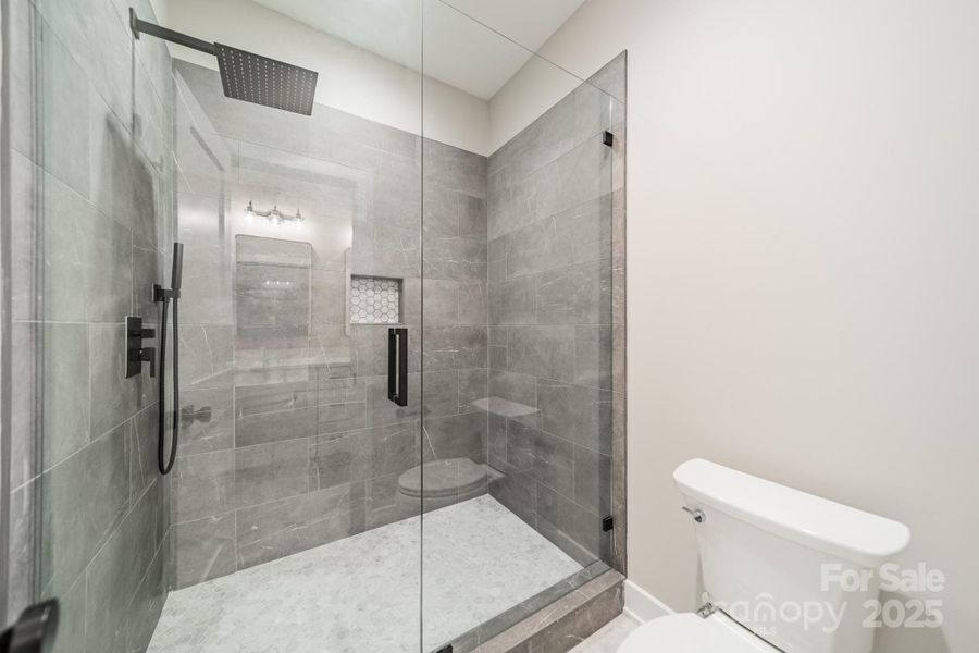 The Lower Level Full Bathroom offers gorgeous tilework in the shower