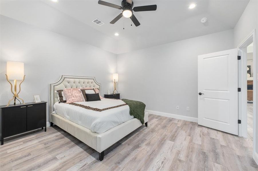 Bedroom with ceiling fan and light hardwood / wood-style flooring