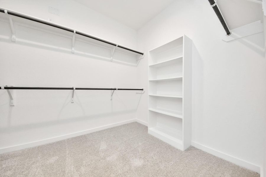 Walk-in closet that epitomizes luxury and practicality. This generously sized space features built-in shelving, offering abundant room for impeccable organization. High ceilings and recessed lighting create a bright and welcoming ambiance. Walk-in closet that epitomizes luxury and practicality. This generously sized space features built-in shelving, offering abundant room for impeccable organization. High ceilings and recessed lighting create a bright and welcoming ambiance.