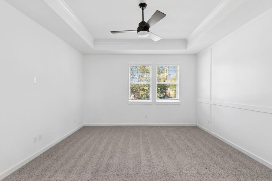 Spacious primary suite with feature wall