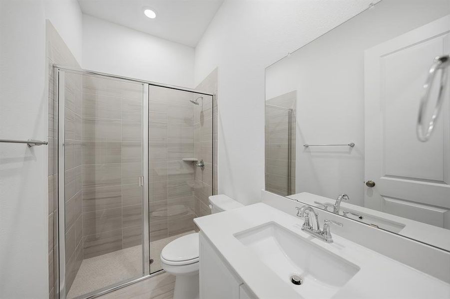 Full bath featuring vanity and a shower stall