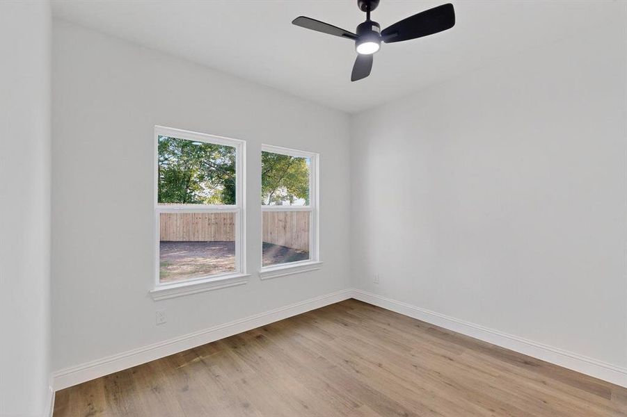 Empty room with light wood-style flooring and a ceiling fan