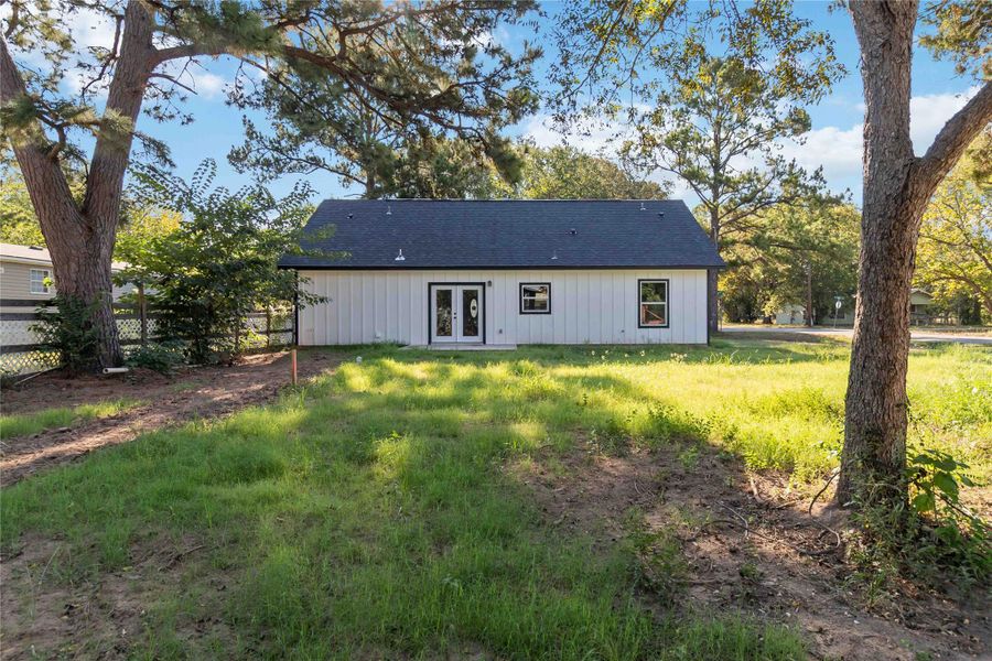 Rear view of property with french doors and a shingled roof