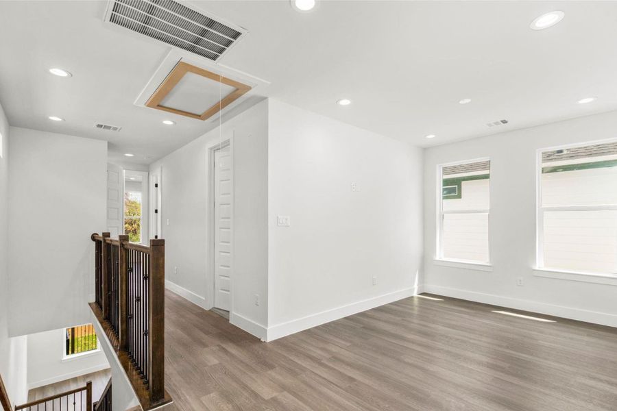 Upstairs loft area with recessed lighting and oversized windows, ideal for a second living space or office. Upstairs loft area with recessed lighting and oversized windows, ideal for a second living space or office.