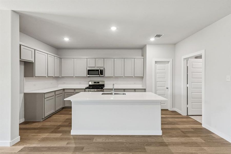 Kitchen in the Oscar home plan by Trophy Signature Homes – REPRESENTATIVE PHOTO