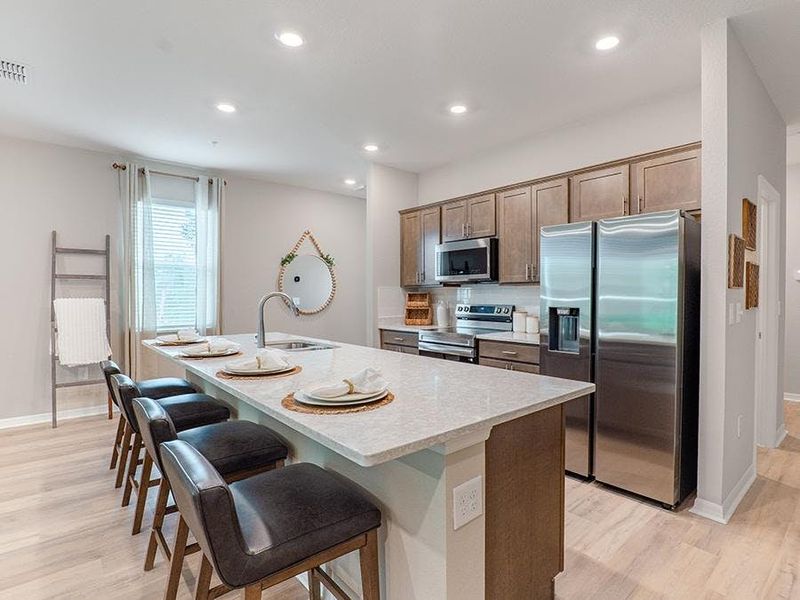 Your bright, open kitchen is complete with beautiful finishes and eat-in space at the island - Birch townhome by Highland Homes Your bright, open kitchen is complete with beautiful finishes and eat-in space at the island - Birch townhome by Highland Homes