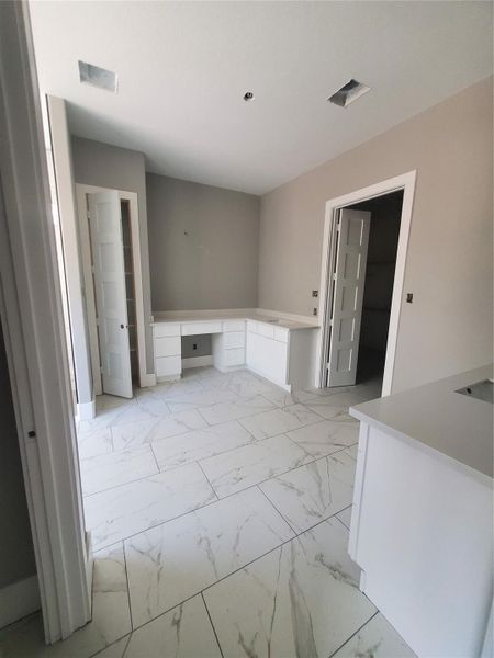 PRIMARY BATH WITH DOUBLE SINKS WHITE MARBLE PATTERN TILE