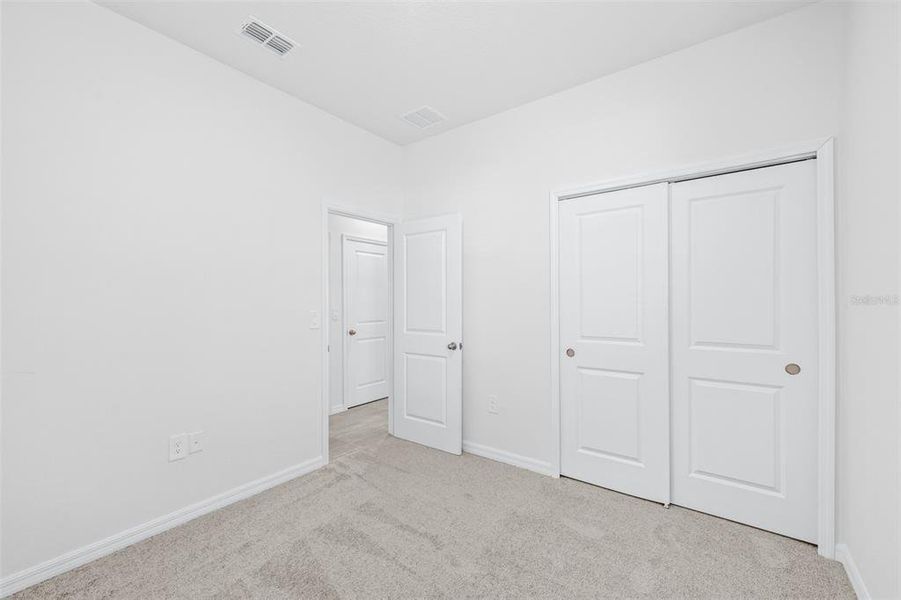 Spacious, unfurnished interior of a new home in The Grove at Stuart Crossing - Premier Series, Bartow (Image 25).