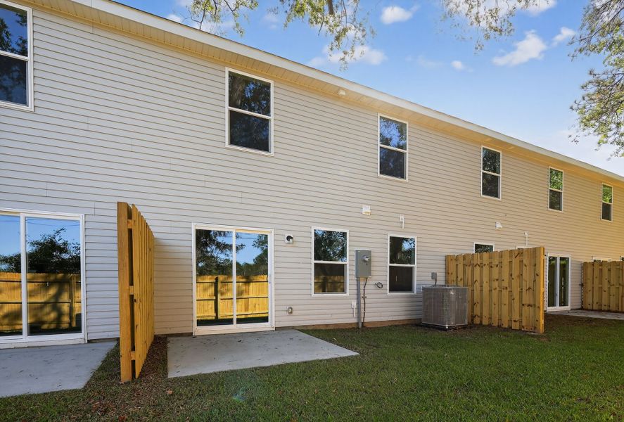 A house with a yard and a fence.