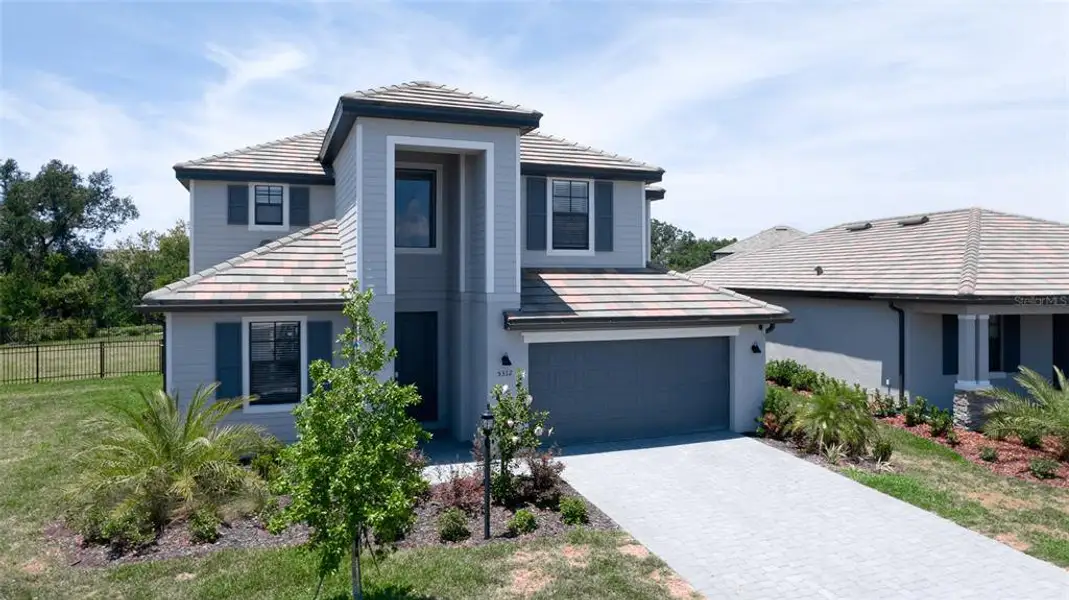 Front exterior of a new home in , Bradenton, FL, highlighting curb appeal (Image 28).