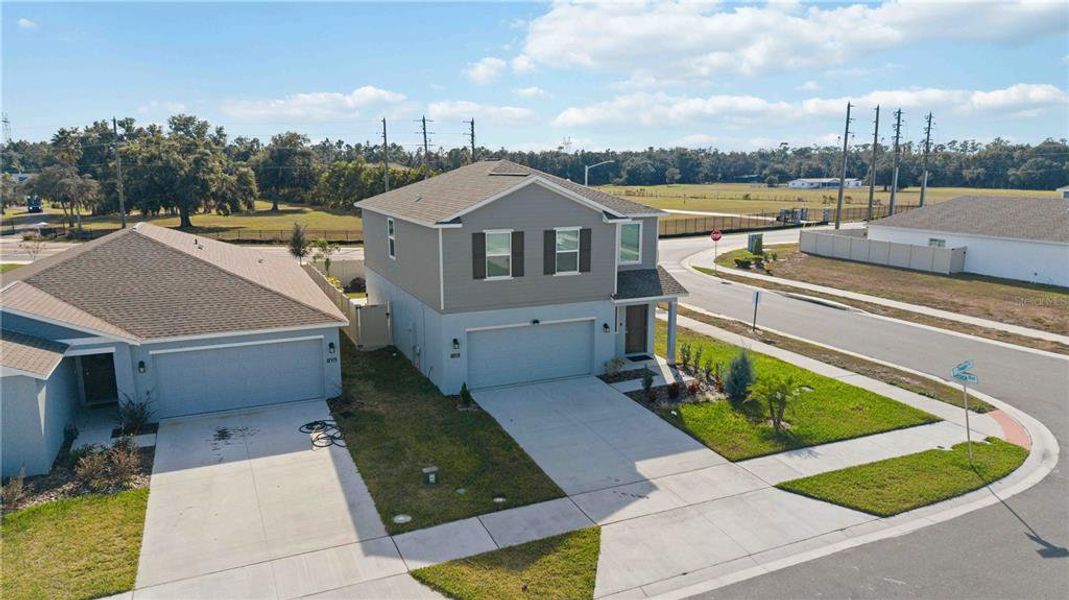 Front exterior of a new home in Peace Creek Reserve: Manor Key Collection, Winter Haven, FL, highlighting curb appeal (Image 33).