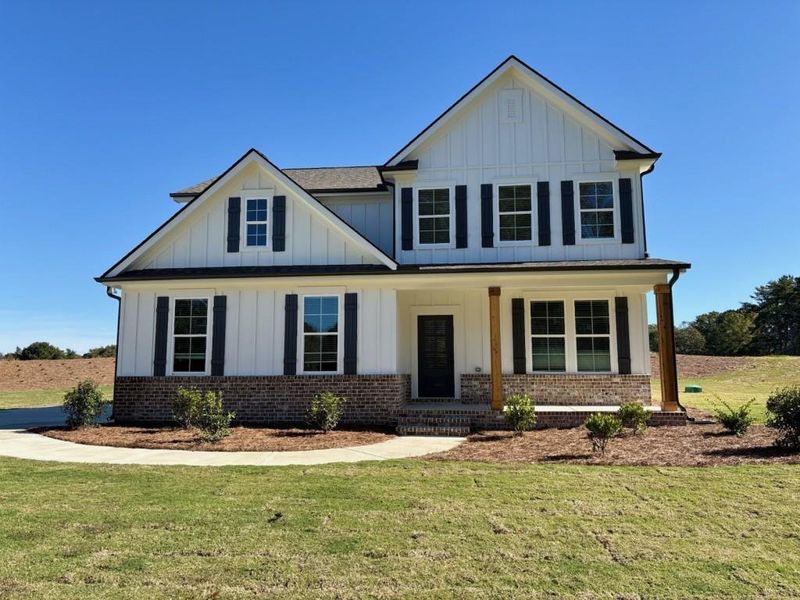 Front exterior of a new home in Magnolia Ridge, Monroe, GA, highlighting curb appeal (Image 1).