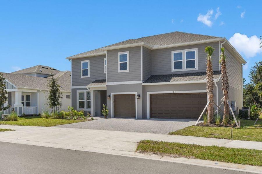 Front exterior of a new home in Ardisia Park, New Smyrna Beach, FL, highlighting curb appeal (Image 2).