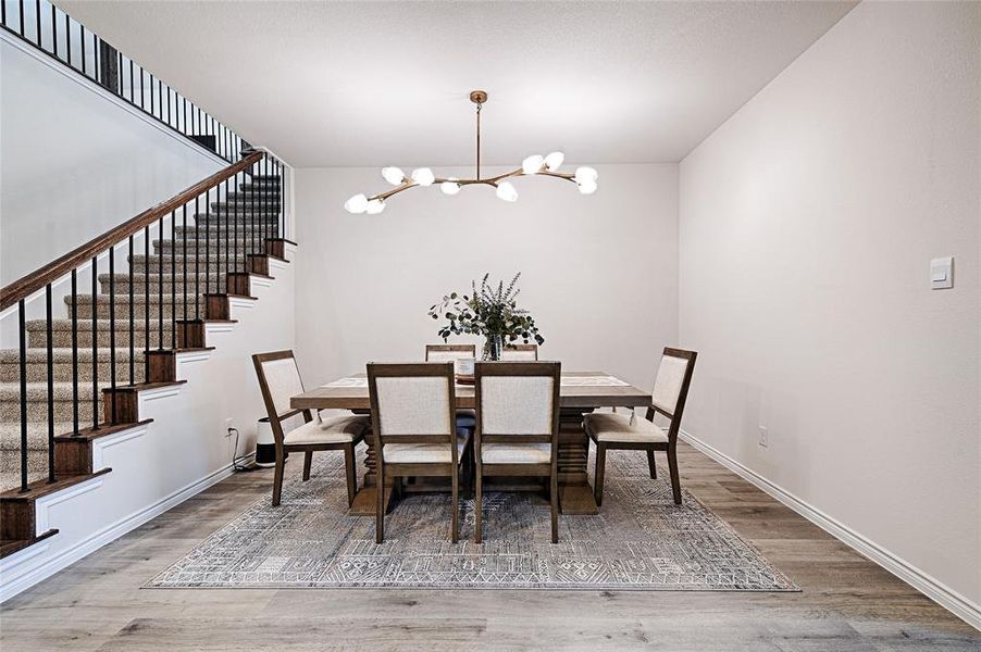 Dining area with a chandelier and hardwood / wood-style floors