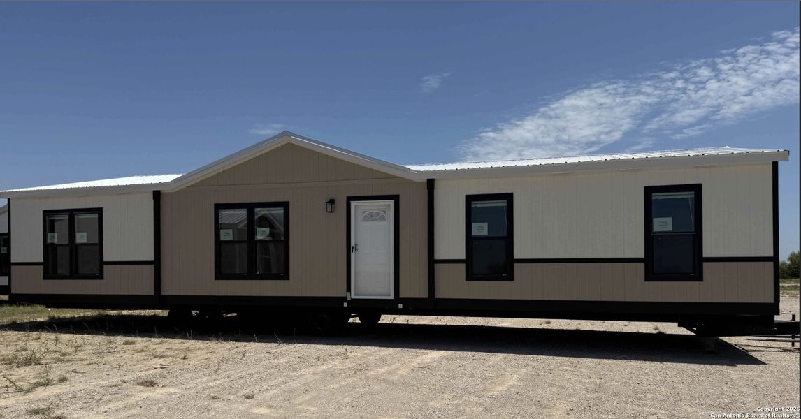 Front exterior of a new home in , Poteet, TX, highlighting curb appeal (Image 1).