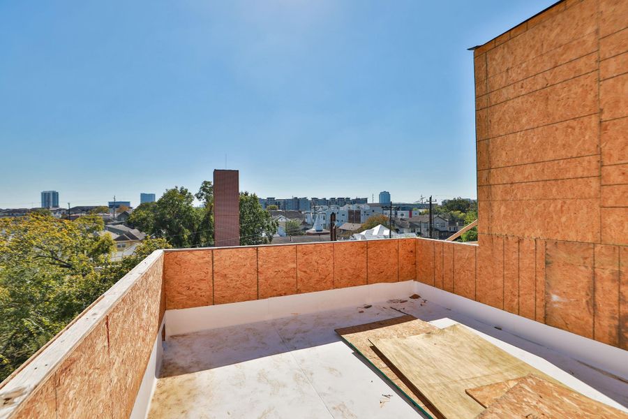 Spacious rooftop terrace under construction with urban views, offering potential for customization and outdoor enjoyment. Spacious rooftop terrace under construction with urban views, offering potential for customization and outdoor enjoyment.