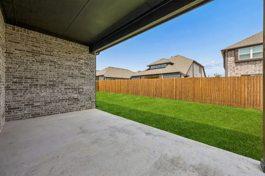 Exterior details and patio area of a home in Country Lakes, Denton (Image 20).