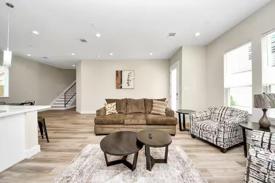 Large windows bring natural light into the heart of the home, while recessed lighting keeps the space bright well into the evening.