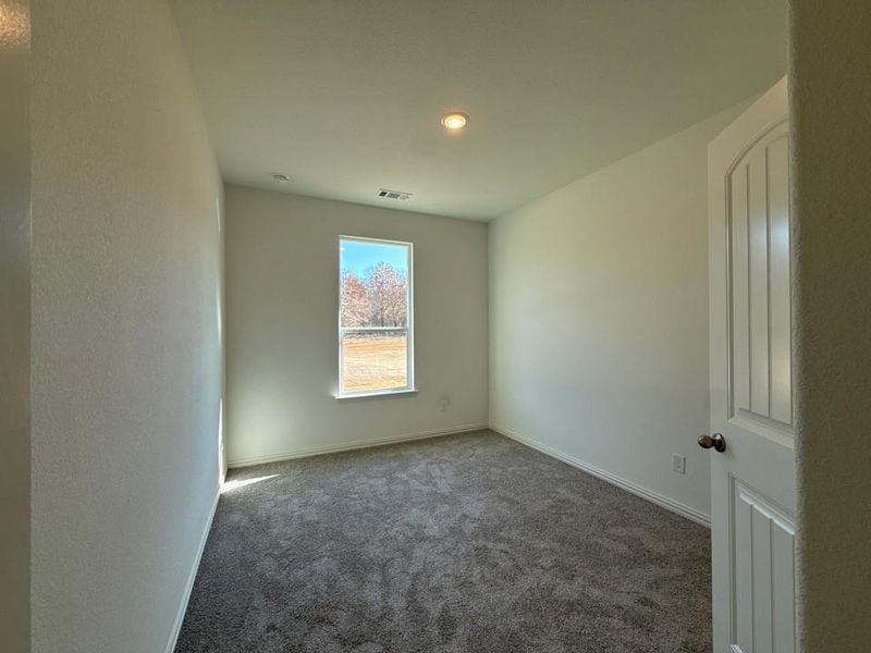 Carpeted spare room featuring baseboards and recessed lighting