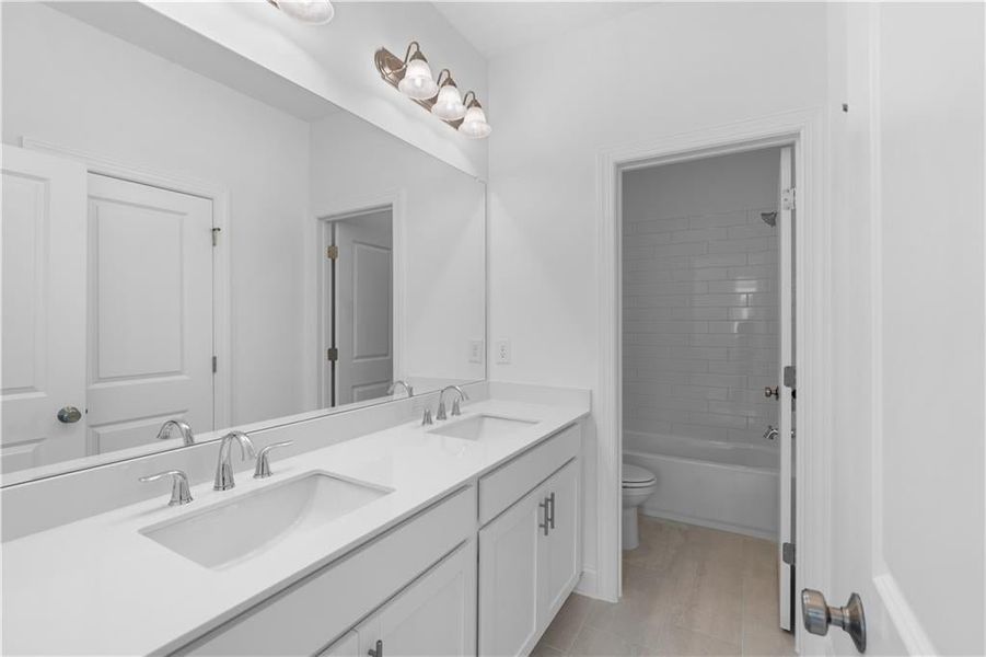 Secondary bathroom with separate sinks, and tub/shower combo - Pictures represent a previously built home