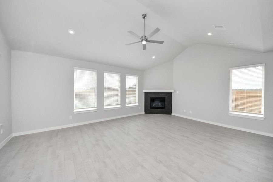 Family room flooded with natural light through the expansive windows. The premium tile flooring adds a touch of luxury to the space, creating the perfect setting for relaxing moments and cherished gatherings with loved ones. Sample photo of completed home with similar floor plan. Actual colors and selections may vary. Family room flooded with natural light through the expansive windows. The premium tile flooring adds a touch of luxury to the space, creating the perfect setting for relaxing moments and cherished gatherings with loved ones. Sample photo of completed home with similar floor plan. Actual colors and selections may vary.