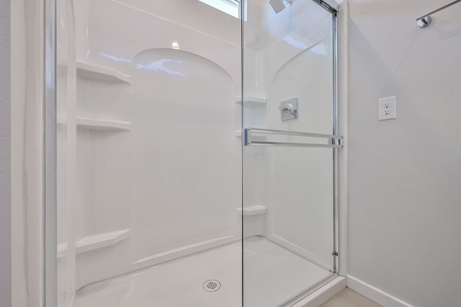 A shower with a glass door. A shower with a glass door.