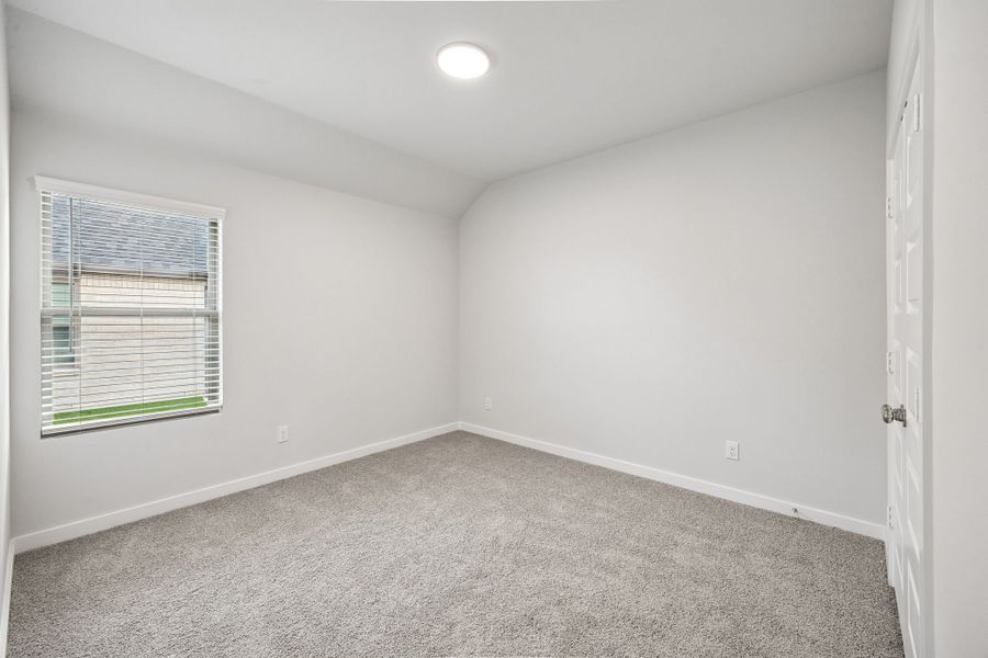 Bedroom in the Heisman home plan by Trophy Signature Homes – REPRESENTATIVE PHOTO