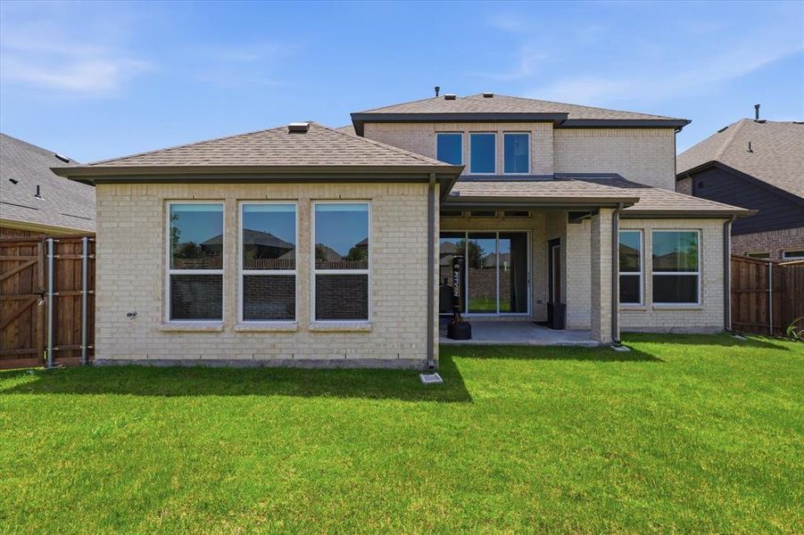 Exterior details and patio area of a home in Valencia on The Lake, Little Elm (Image 22).