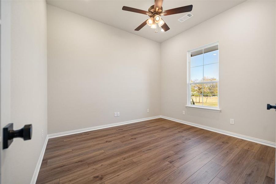 Empty room featuring wood finished floors and ceiling fan