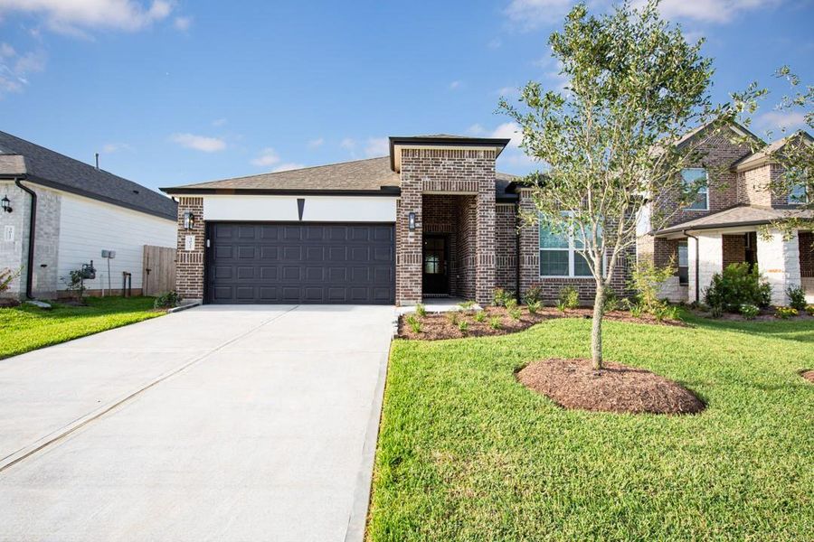 Front exterior of a new home in Bluestem, Brookshire, TX, highlighting curb appeal (Image 2). Front exterior of a new home in Bluestem, Brookshire, TX, highlighting curb appeal (Image 2).