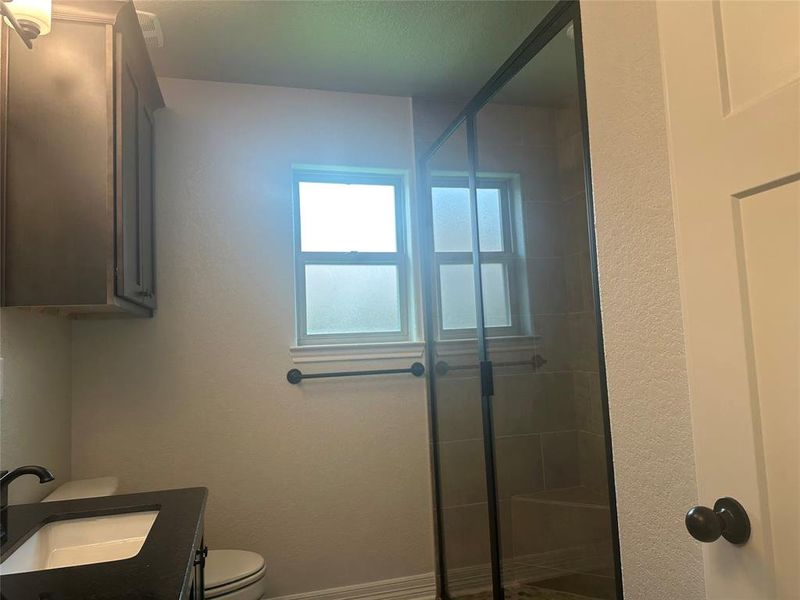 Full bathroom with a shower stall and vanity