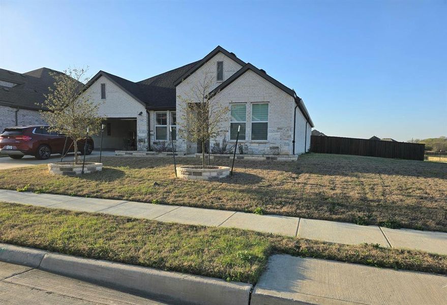 Front exterior of a new home in , Hickory Creek, TX, highlighting curb appeal (Image 27).