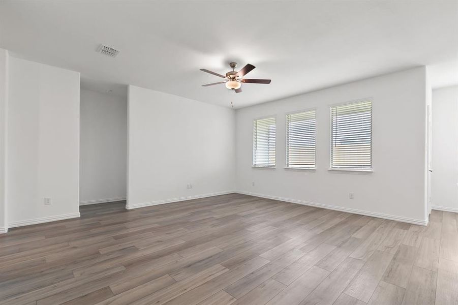 Spare room featuring dark hardwood / wood-style flooring and ceiling fan