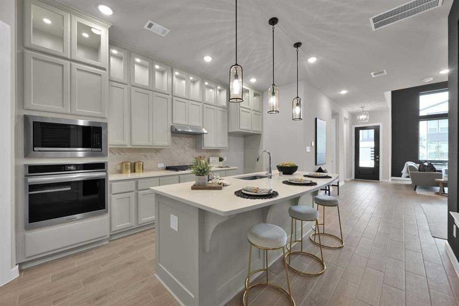 Large island with seating, ideal for casual dining and entertaining. (Original Builder Staged Photo 2024)
