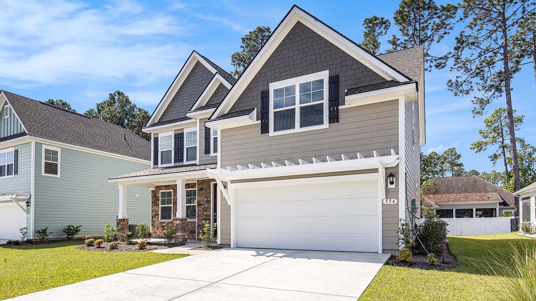 Front exterior of a new home in Heron Pointe, Myrtle Beach, SC, highlighting curb appeal (Image 18).