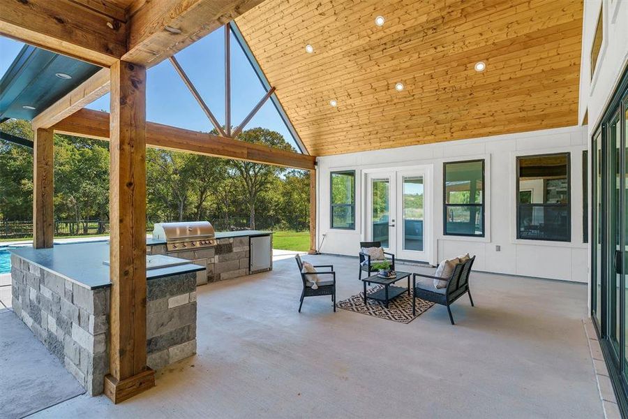 View of patio / terrace featuring exterior kitchen, french doors, outdoor lounge area, and a grill