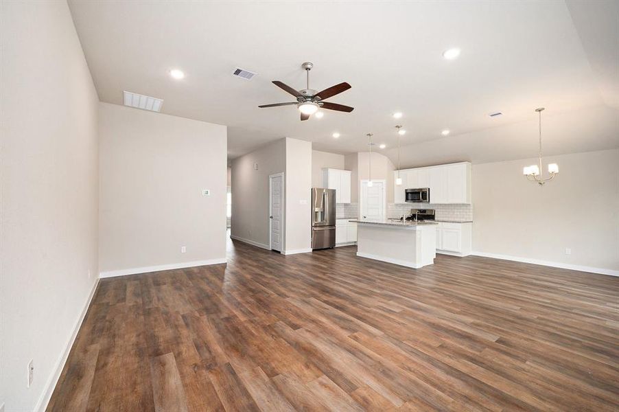 Large living room/ open kitchen space is the perfect space for entertaining. The has high ceiling throughout the living area.