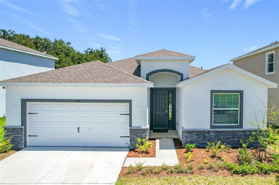 Front exterior of a new home in Farm at Varrea Villas, Plant City, FL, highlighting curb appeal (Image 2). Front exterior of a new home in Farm at Varrea Villas, Plant City, FL, highlighting curb appeal (Image 2).