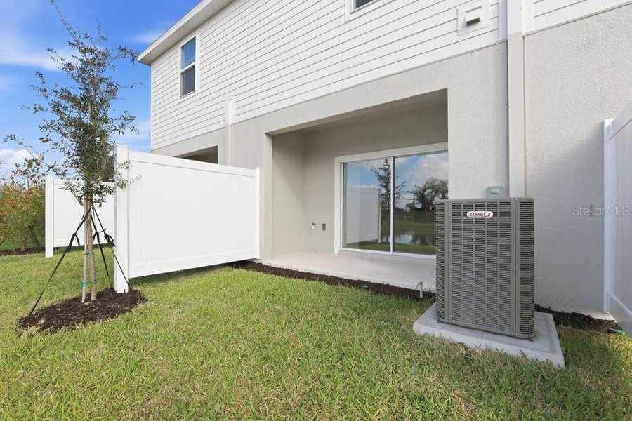 Exterior details and patio area of a home in The Towns at Firethorn, Parrish (Image 18).