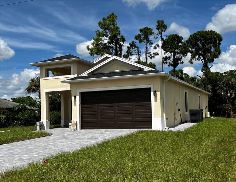Front exterior of a new home in , Lehigh Acres, FL, highlighting curb appeal (Image 1).
