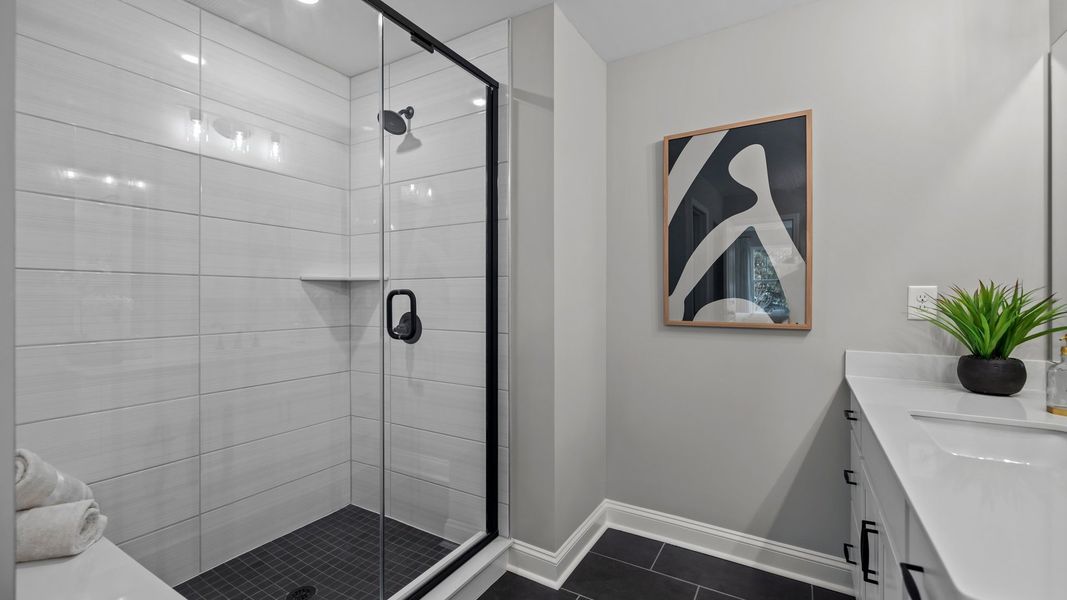 Walk-in fully tiled shower with seat, in the new Adaline Design by DRB Homes Charlotte, NC