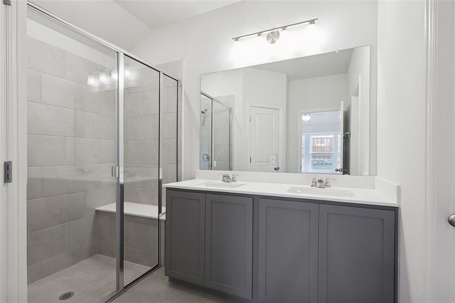 Bathroom with double vanity and a shower stall