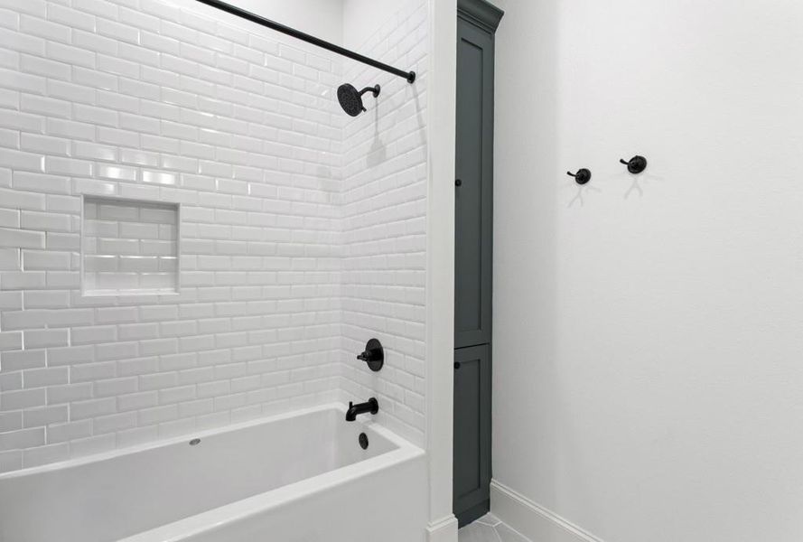 Bathroom featuring shower / bathtub combination and tile patterned flooring