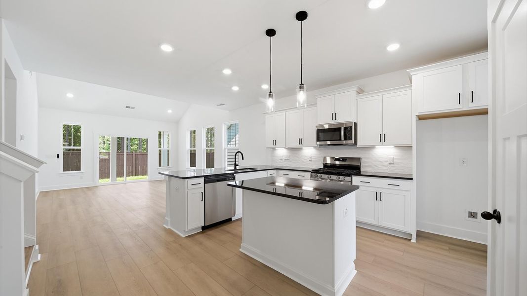 Well-designed kitchen with a center island and tasteful finishes that elevate everyday living Well-designed kitchen with a center island and tasteful finishes that elevate everyday living