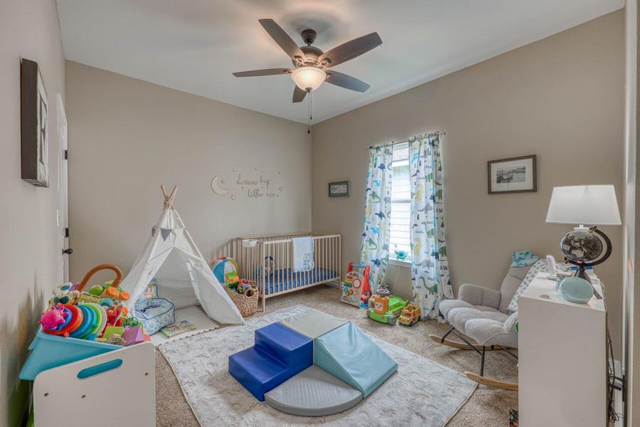 Neutral tone walls with an overhead ceiling fan and light fixture