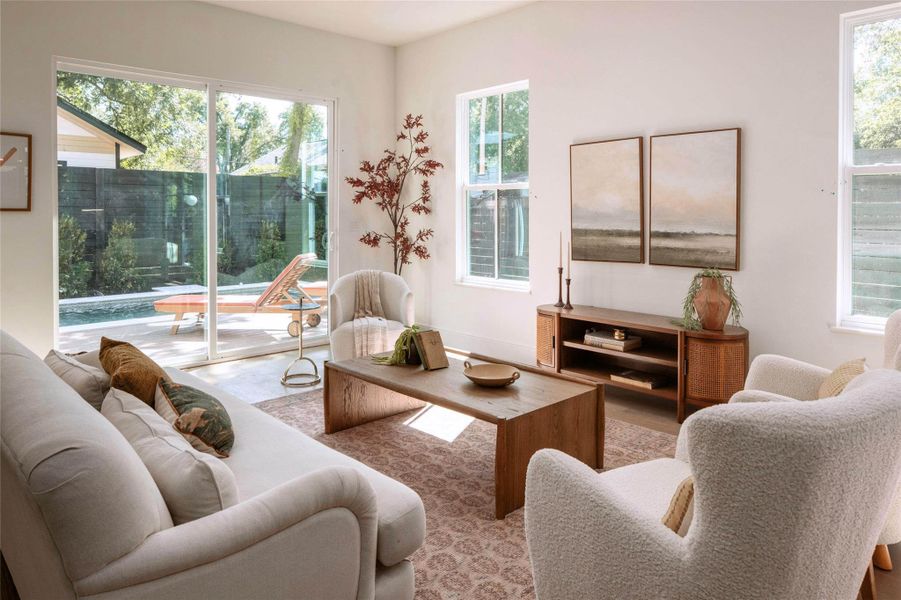 Natural light floods this living space, highlighting clean lines and a harmonious connection to the private outdoor oasis.