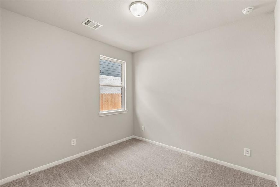 Your secondary bedroom features plush carpet, fresh paint, closet, and a large window that lets in plenty of natural lighting.