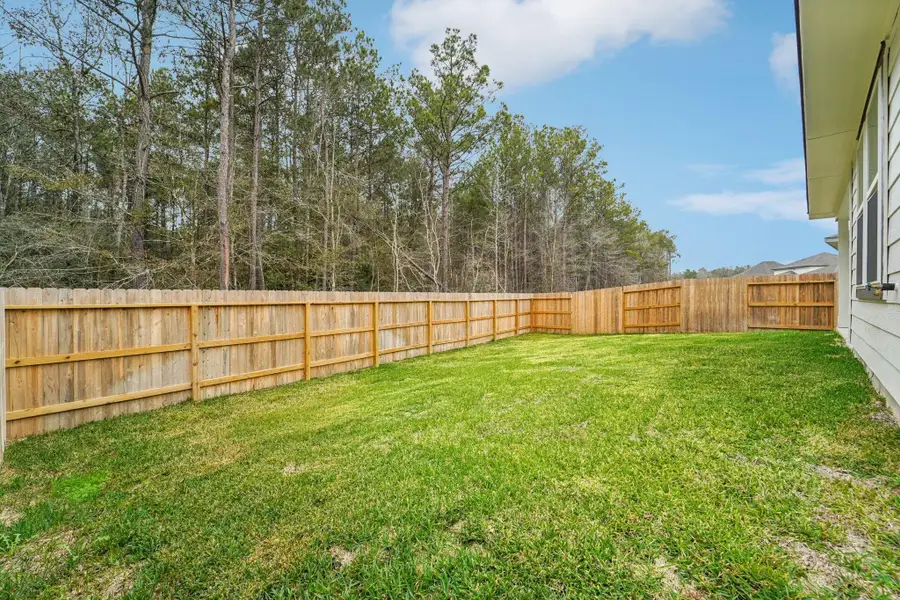 Exterior details and patio area of a home in Landing Meadows - Traditional Series, New Caney (Image 20).
